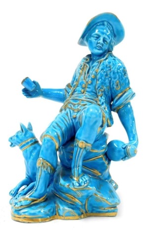 A late 19thC Continental turquoise porcelain figure group, modelled as a boy seated on a rock with a bottle and beaker, a dog at its side, raised on a naturalistic rocky base, pseudo Sevres mark, 15cm high.