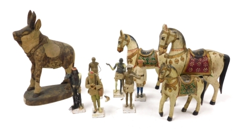 Three early 20thC Indian painted wooden carvings of horses, further wooden carving, and six painted terracotta and cloth bound figures. (AF)