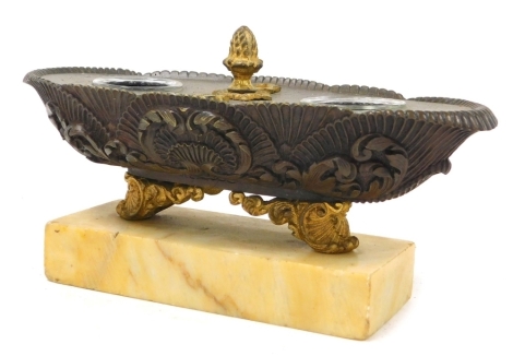 A late 19thC French bronze and ormolu desk stand, of oval fluted and shell scroll form, raised on scrolling feet, over a rectangular yellow marble base, 19cm wide.