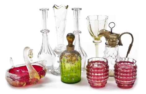 A group of glassware, including two Georgian toddy lifters, Venetian ruby glass dish modelled as a swan, Continental green glass scent bottle with gilt and enamel overlay, and a cut glass and plate mounted jug, possibly for communion. (9)