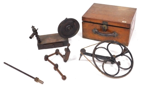 A Georgian wooden lace bobbin winder, raised on a rectangular base, with frieze drawer containing lace accoutrements, lace maker's vice, cast iron wheel, with brace attachment, and a mahogany box, 21cm high, 40cm wide, 32cm deep. (4)