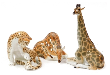 A Lomonosov USSR porcelain figure of a giraffe, 31cm high, further giraffe, 26cm wide (AF), and a seated leopard, 17cm high.