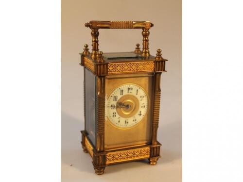 An Edwardian brass carriage clock with part canted pillars and indented