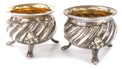 A pair of 19thC French silver open salts, each of circular part fluted form raised on three lion's paw feet, 1.46oz,