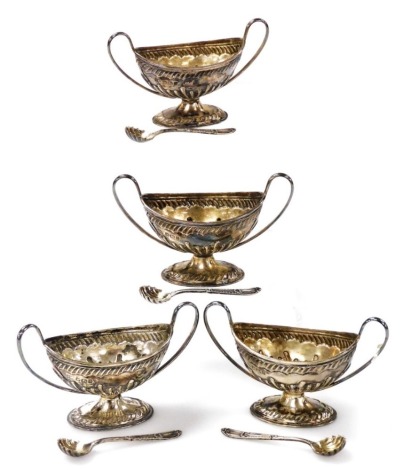 A set of four Victorian silver two handled open salts, with part fluted decoration on pedestal bases, together with four salt spoons, Sheffield 1897 and 1899, 5.08oz.