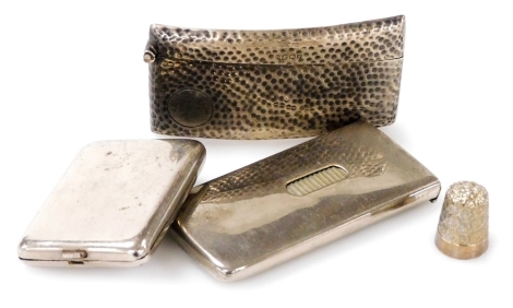 A George V silver calling card case, with all over hammered decoration, Robert Pringle & Sons, Chester 1915, 1.34oz, together with a silver thimble, a plated card dispenser and a match case, (4).