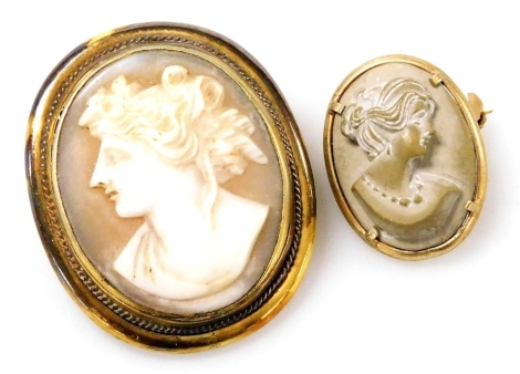 A late 19thC Italian lava cameo brooch, bust portrait of a lady, in a yellow metal mount, indistinctly stamped, and a shell cameo brooch, bust portrait of a lady, in a gold plated mount, 32mm x 26mm.