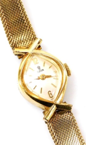 A Tudor lady's gold plated wristwatch, oblong silvered dial bearing Arabic numerals at 12 and 6, Swiss 21 jewelled movement, stainless steel back, numbered internally 302221, crown winder, in a plated case with mesh bracelet strap, cased