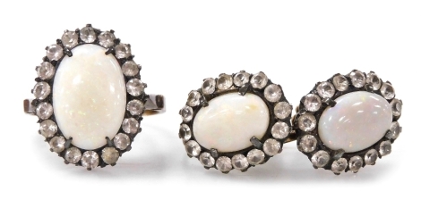 An opal and paste set ring, in a basket mount, set in yellow metal, size L, together with a pair of matching earrings, with screw fittings.