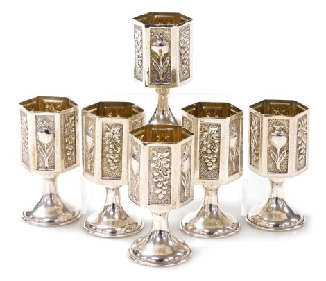 A set of six Continental silver liqueur goblets, each bowl of hexagonal form embossed with flowers and fruit, on pedestal bases, stamp to underside MC.02 Stirling 925, 6.06oz.