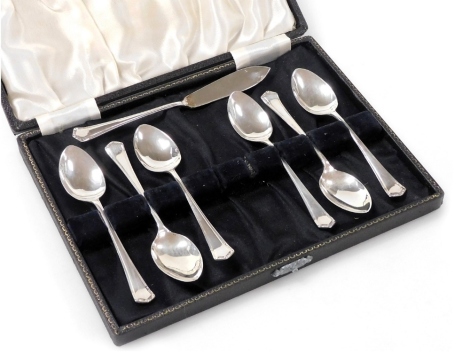 A set of six George VI silver coffee spoons, each with a shaped and engraved handle, Birmingham 1944, together with a similar butter knife, 2.95oz, in an associated fitted case.