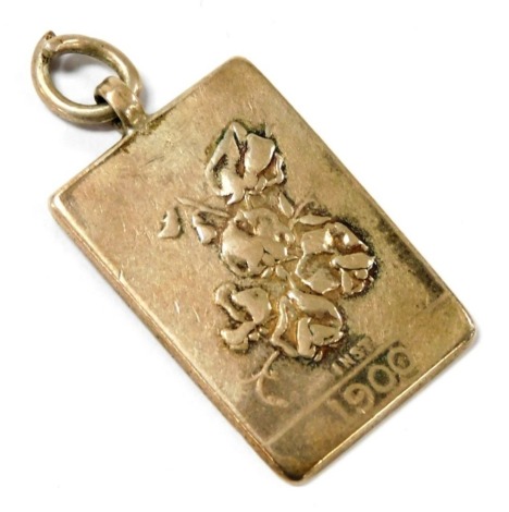 An Edward VII silver pendant, of rectangular form, for The National Sweet Pea Society, embossed to the front with flowers, verso presentation engraved, boxed, Walker and Hall, Sheffield 1909, 13.9g.