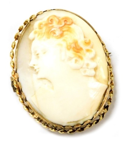 A shell cameo brooch, bust portrait of a lady, in a yellow metal mount, stamped 9ct, 4cm high, 3cm wide.