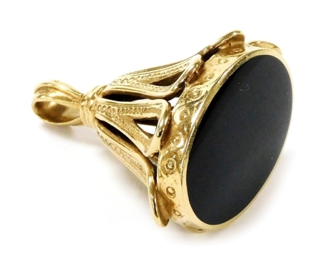 A 9ct gold and black onyx pendant fob, the onyx undecorated, in a basket mount, 11.4g all in.