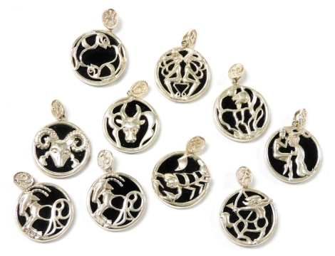 Ten Zodiac silver and black onyx pendants, approx 30g.