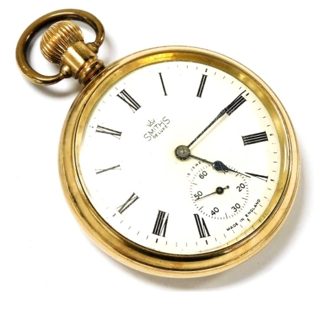 A Smiths de Luxe gold plated gentleman's pocket watch, open faced, keyless wind, circular dial bearing Roman numerals, subsidiary seconds dial, fifteen jewelled movement, the case of plain form, back presentation engraved.