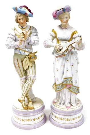 A pair of late 19thC French bisque porcelain figures, modelled as a gallant and lady in 16thC costume, the gallant standing playing a recorder, against a fluted column, the lady playing a lute, both raised on a circular socle base, 59cm high. (AF)