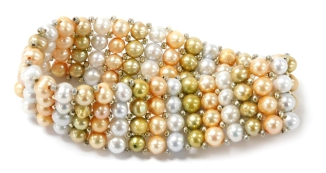 A three colour four strand pearl bracelet, set with orange, gold, and silver pearls at intervals.