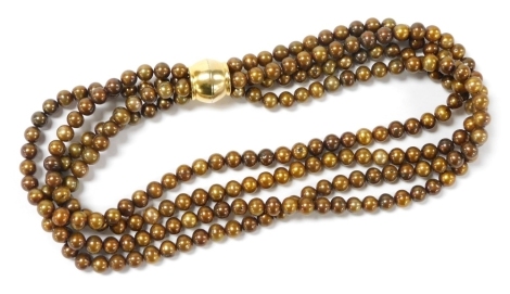 A four strand brown tinted cultured pearl necklet, of uniform size, on a magnetic clasp, 44cm wide.