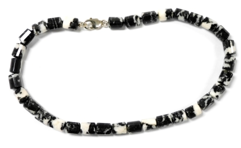 A Zebra Jasper necklet, each link of faceted barrel form, on a silver lobster claw clasp, 48.5cm wide.