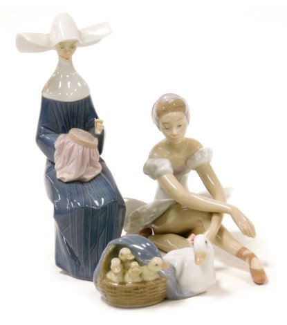 A Lladro porcelain figure modelled as a seated ballerina, 14cm high, together with a Lladro figure group of a goose and goslings, 19cm wide, and a Lladro figure of a seated nun, 21cm high. (AF)