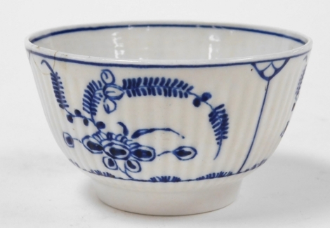 A late 18thC Caughley porcelain tea bowl, with vertical fluting, decorated in blue and white with floral sprays, crescent mark, 8cm diameter.