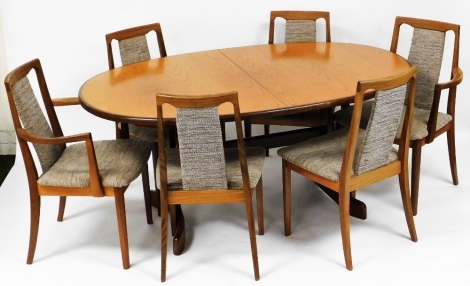 A mid century G Plan teak extending dining table, the oval top raised on shaped legs with stretcher, 72cm high, the top 104cm x 156cm, together with a set of six (4+2) G Plan dining chairs, each with an upholstered back and seat. The upholstery in this lo