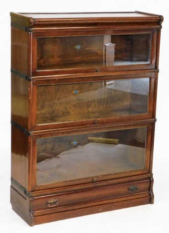 A 20thC oak Globe Wernicke bookcase, with three sections, each with a glass fronted panel, above a drawer to the base, 120cm high, 86cm wide, 32cm deep.