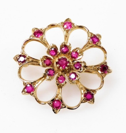 A circular ruby set floral bar brooch, in yellow metal, 4.7g.