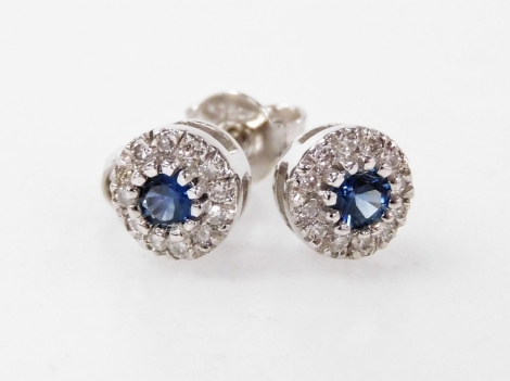 A pair of 18ct white gold sapphire and diamond cluster stud earrings.