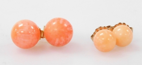 A pair of 9ct gold and coral single stone stud earrings, and a further pair of coral stud earrings, (2).