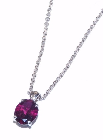 A 9ct white gold and rhodolite pendant, with an oval cut stone, on a 9ct white gold trace link neck chain, with lobster claw clasp, 3.9g.