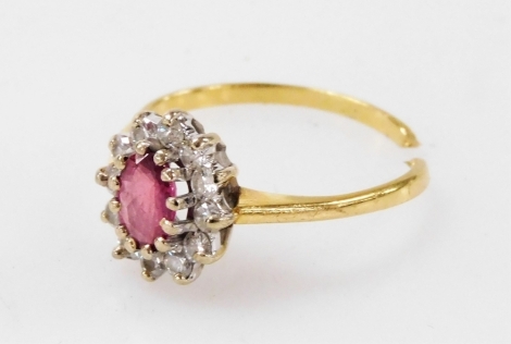 An 18ct gold, ruby and diamond ring, in an oval basket setting, cut, size K, 2.1g.
