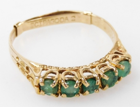 A 9ct gold and emerald five stone ring, in a high claw setting, size Q, 2.0g.