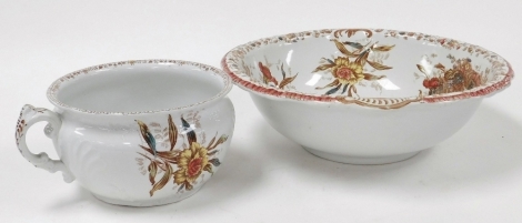 A 19thC pottery wash bowl, transfer printed decorated with flowers in pinks and yellows, 41cm diameter, together with a matching chamber pot.