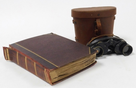 An early 20thC scrap album, containing Christmas and greetings cards, together with a pair of Kershaw Bino Prism number 2 MK11 binoculars, number 100035, in a leather case.