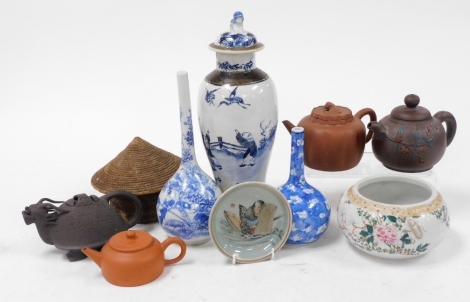 A group of Chinese ceramics, including red ware and terracotta teapots, blue and white vase and cover, further blue and white, and a Japanese bowl. (a quantity)