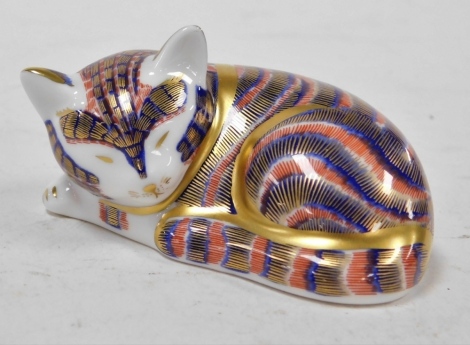 A Royal Crown Derby porcelain paperweight modelled as a sleeping kitten, gold stopper and red printed marks, 9cm wide.