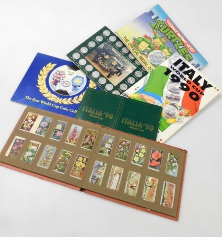 A quantity of coin collection sets, to include Esso 1990 World Cup collection, Shell Historic Car, Teenage Mutant Hero Turtles, together with an album of cigarette cards.