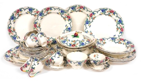 A Royal Cauldon Victoria pattern pottery part dinner and tea service, including vegetable tureens, dinner, soup and dessert plates, teacups and saucers.