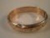 A 9ct gold hinged bangle