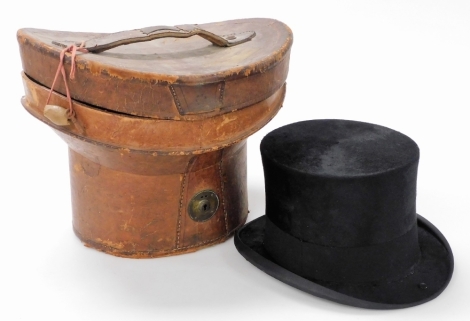 A Harmon and Son brushed black silk top hat, 65 Jermyn Street, London, with a brown leather case.