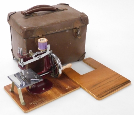 A mid century child's sewing machine, in a leatherette case.