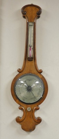 A Victorian oak cased wheel barometer, with a silvered dial and thermometer, 90cm high.