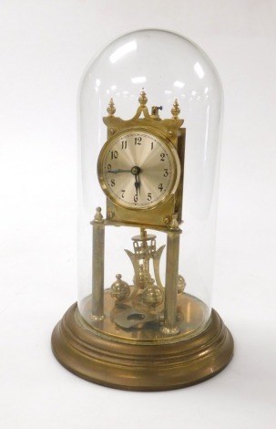 A German brass cased four hundred day anniversary clock, with silvered dial bearing Arabic numerals, on a brass base, with glass dome, with key, 13.5cm high.