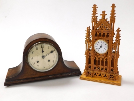 A wooden cased cathedral mantel clock, with pierced and arched tracery, the circular dial bearing Roman numerals, quartz movement, 37cm high, together with an oak cased Napoleon hat mantel clock, silver dial bearing Arabic numerals, eight day movement, wi