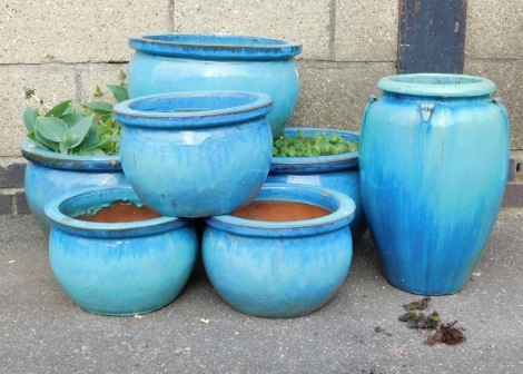 A group of terracotta turquoise glazed plant pots, the largest 39cm diameter. (a quantity)