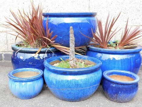 A group of dark blue glazed plant pots, various sizes, the largest 40cm diameter. (a quantity)