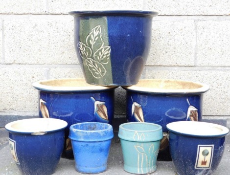 A group of plant pots, to include a pair with incised leaf decoration against a dark blue glaze, 40cm diameter, etc. (a quantity)