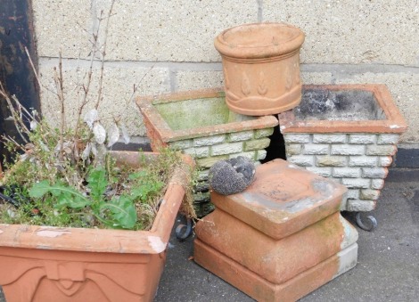 A group of garden plant pots, to include a pair of composition pots with brick work decoration, on wrought metal bases, 36cm high, etc. (a quantity)